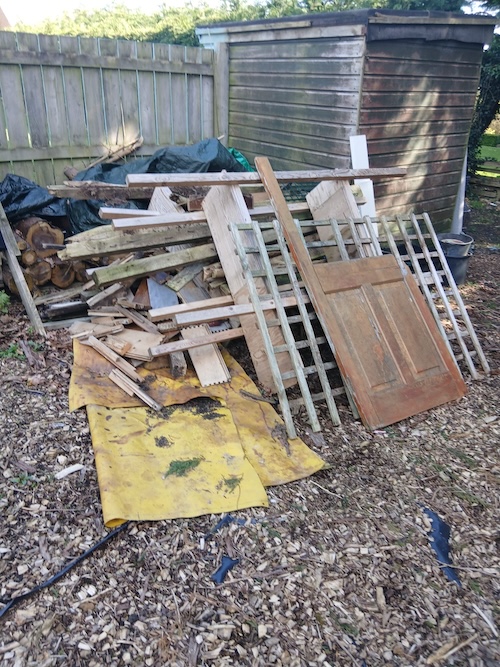 wood and an old door with shed in background